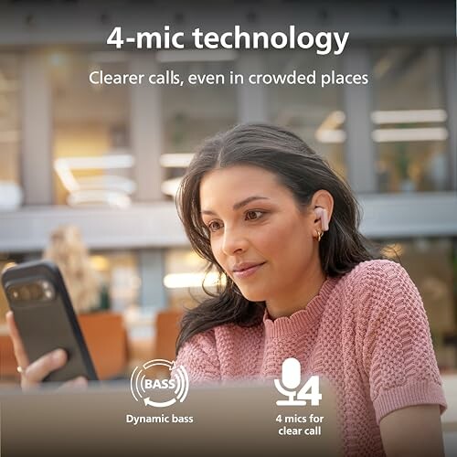 Person using earbuds with 4-mic technology for clearer calls.