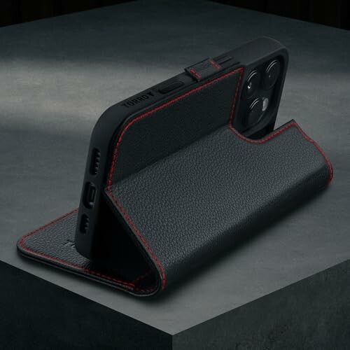 Black leather phone case with red stitching on a table