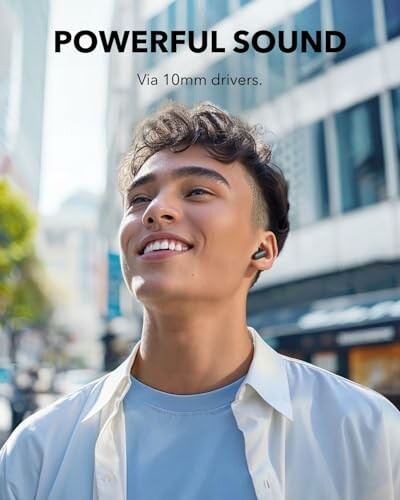 Man enjoying music with earbuds in a city setting.