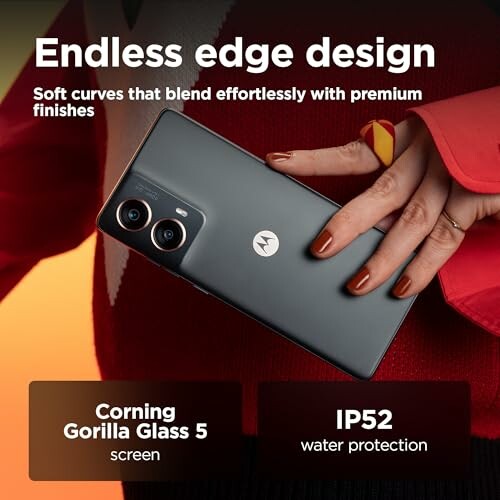 Person holding Motorola smartphone with dual cameras, showcasing endless edge design.