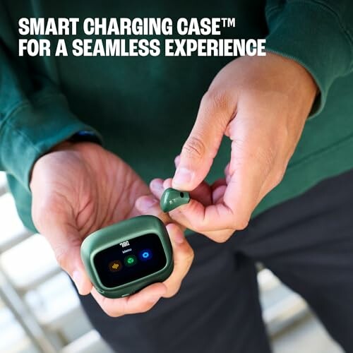 Person holding a smart charging case and earbud.