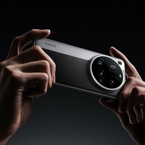 Hands holding a smartphone with a prominent camera module.