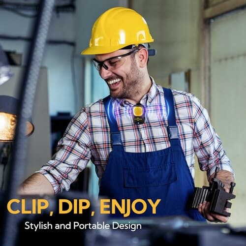 Worker in yellow hard hat and blue overalls wearing a clip-on light.